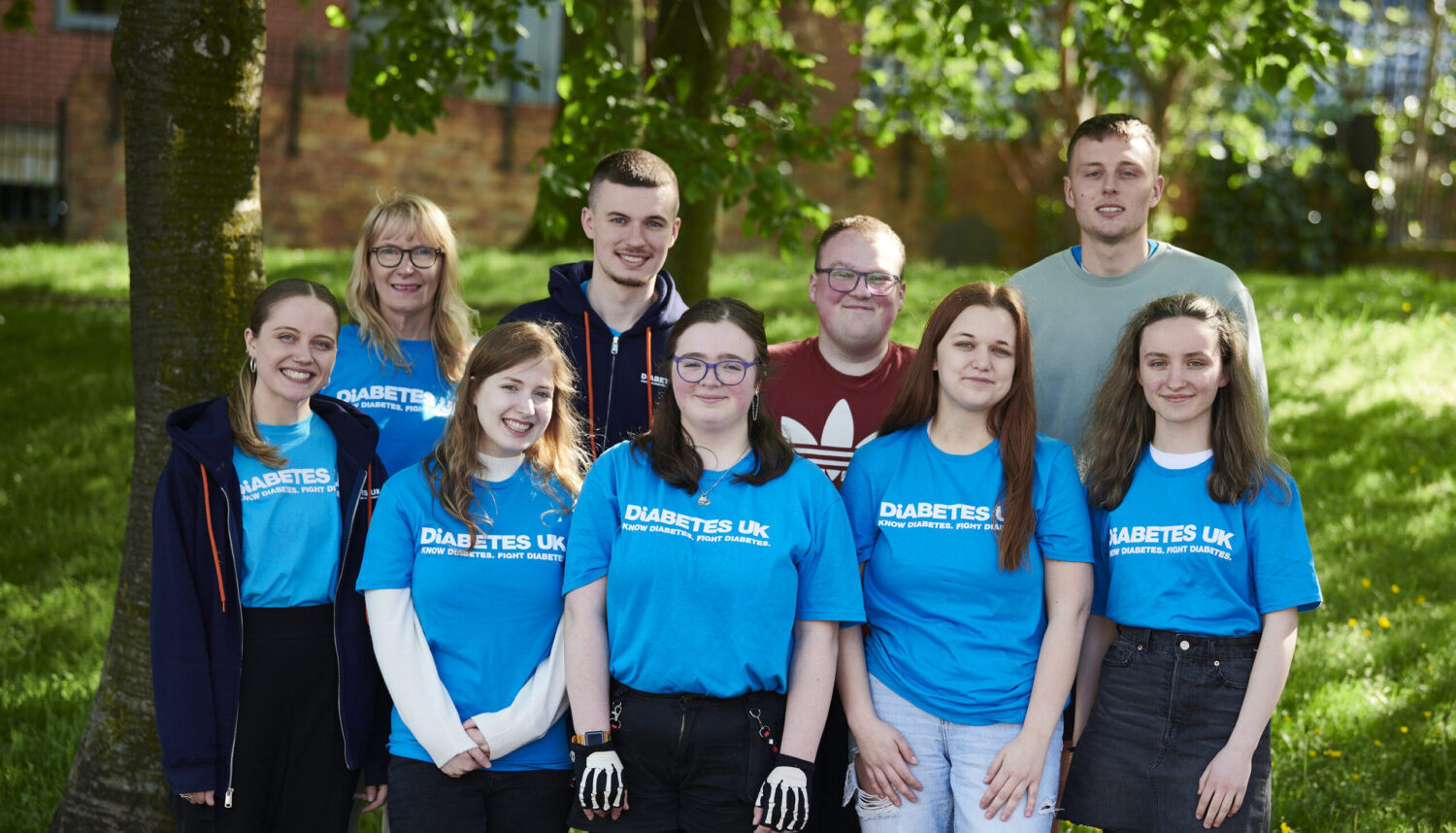A group pose for a photo wearing Diabetes UK t-shirts. Our Lives Our Choices Our Voices - a Steve Morgan Foundation strategic partner.