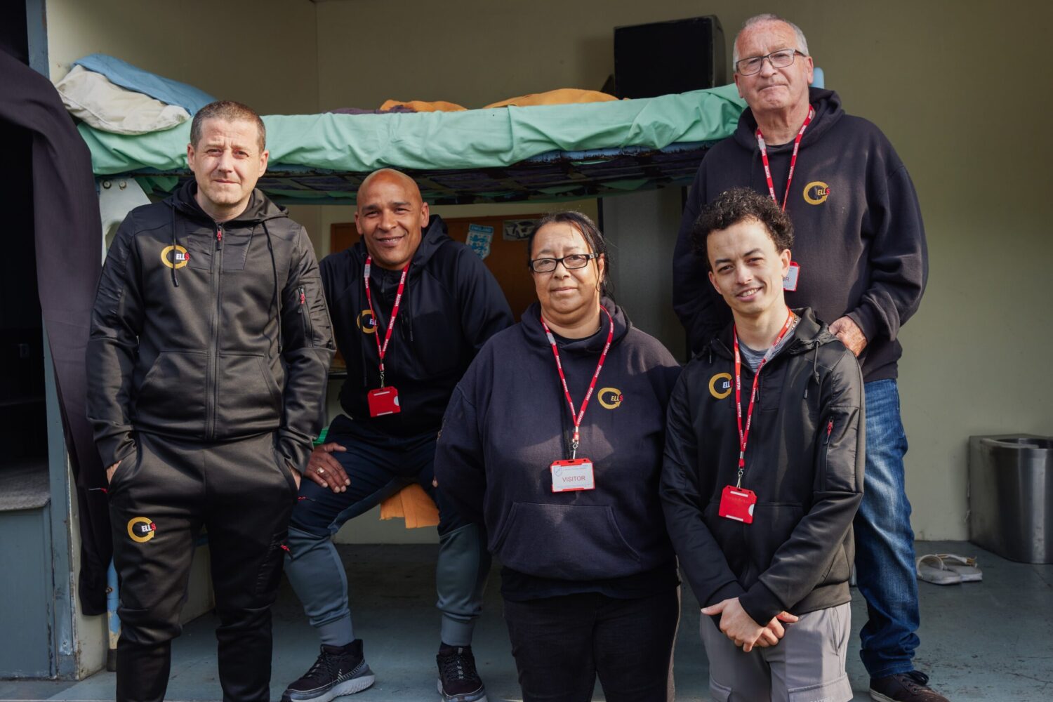 CELLS staff infront of the prison cell mockup