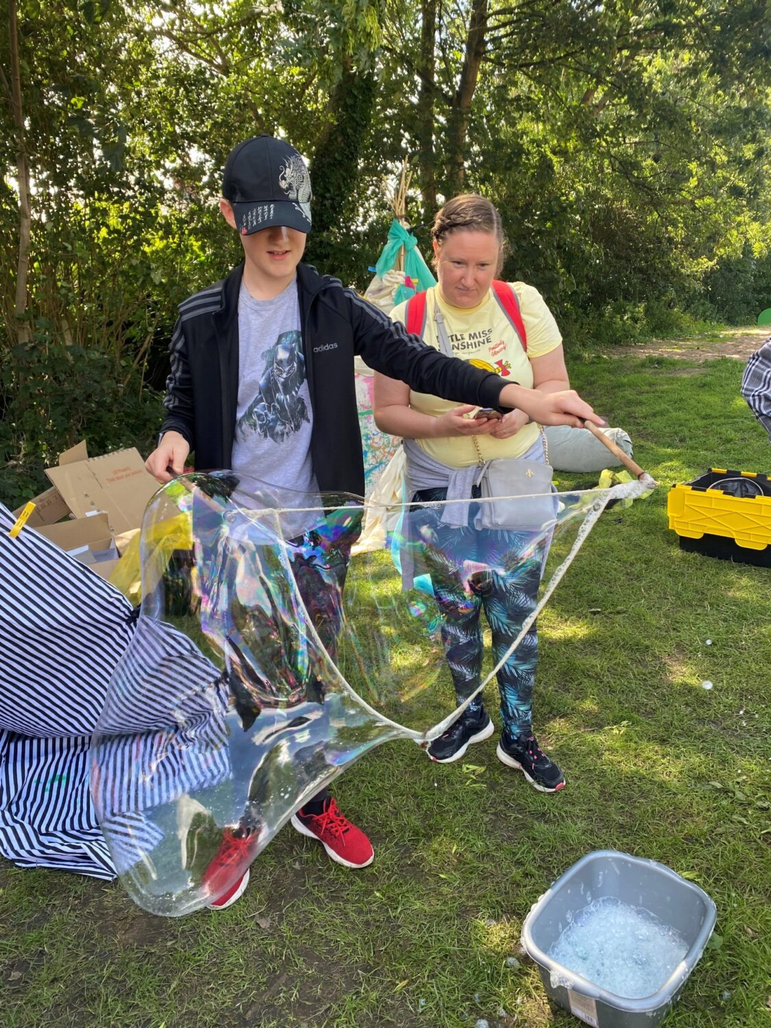 A child creates a large bubble as part of a Fun 4 Kidz day out