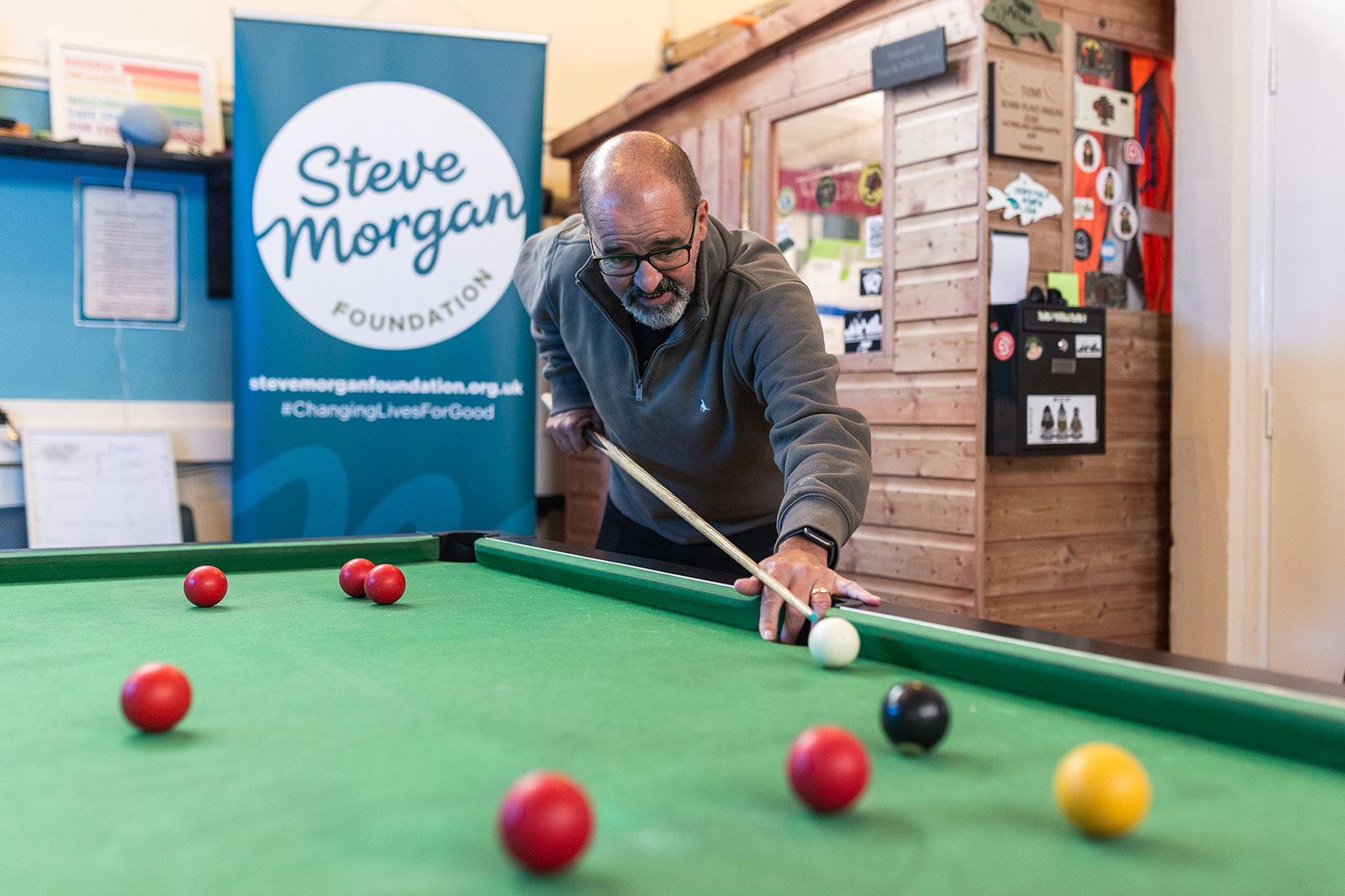 Man playing pool at Sean's Place charity